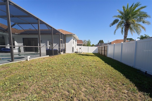 view of yard with glass enclosure, a fenced backyard, and a fenced in pool