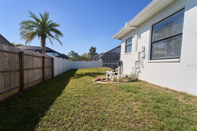 view of yard featuring a lanai and a fenced backyard