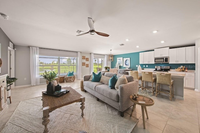 living room featuring visible vents, recessed lighting, light tile patterned floors, baseboards, and ceiling fan