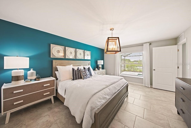 bedroom with light tile patterned floors, baseboards, and a chandelier