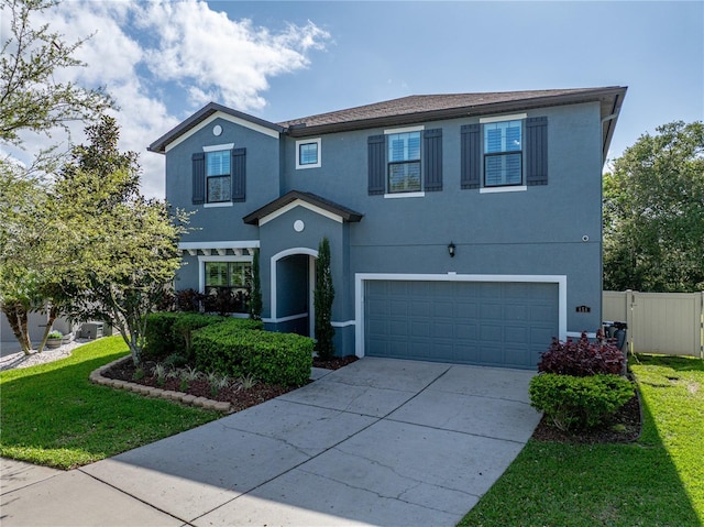 traditional-style home with concrete driveway, fence, a garage, and stucco siding