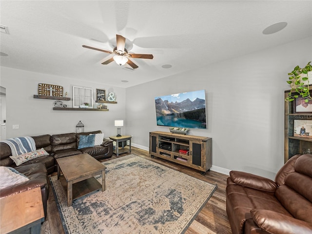 living area featuring visible vents, a ceiling fan, a textured ceiling, wood finished floors, and baseboards