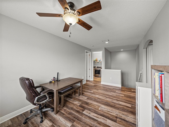 office with a ceiling fan, wood finished floors, baseboards, and a textured ceiling