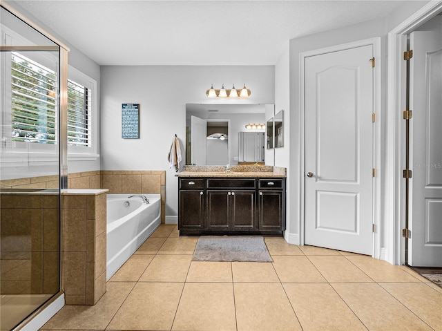 bathroom with tile patterned floors, a shower stall, a bath, and vanity