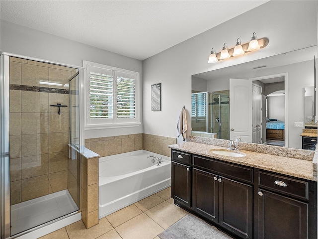 bathroom with connected bathroom, a shower stall, tile patterned flooring, a bath, and vanity