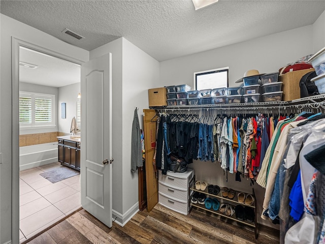 walk in closet featuring wood finished floors and visible vents