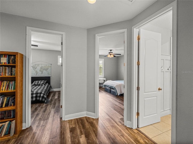 hall featuring baseboards and wood finished floors