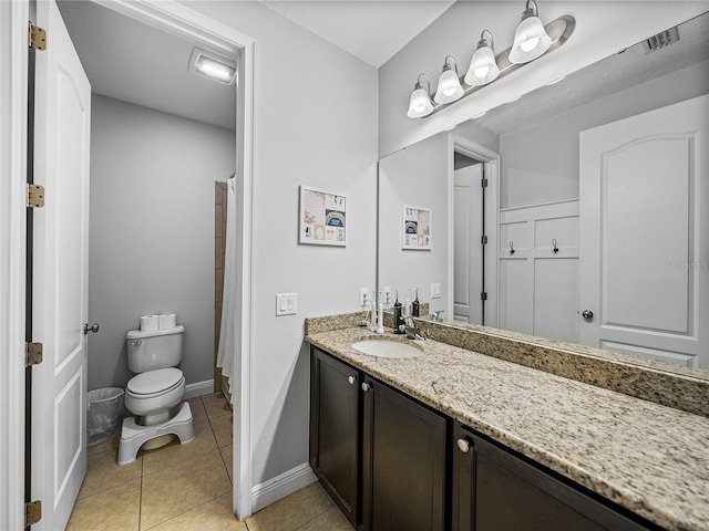 bathroom featuring visible vents, toilet, tile patterned flooring, baseboards, and vanity