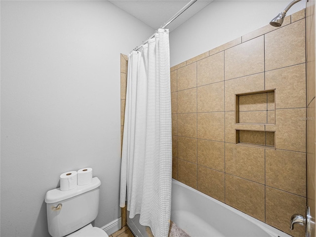 full bathroom featuring shower / tub combo and toilet