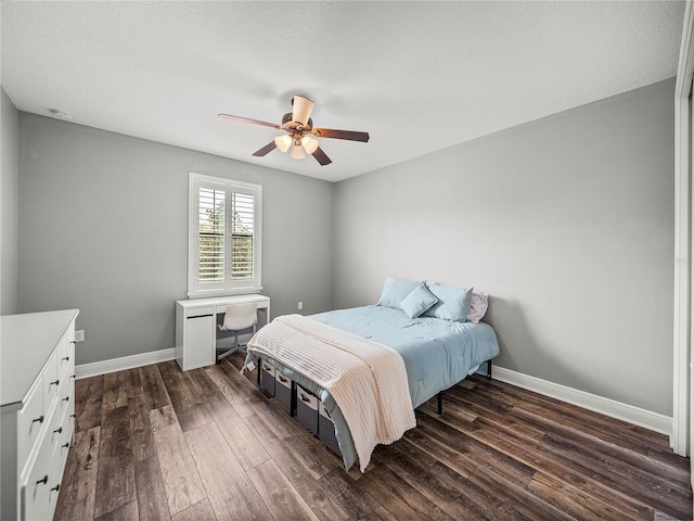 bedroom with baseboards, dark wood finished floors, and a ceiling fan