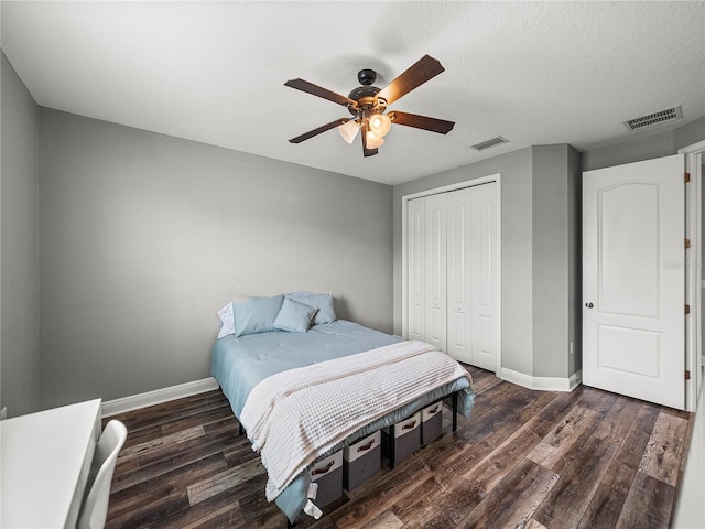 bedroom with visible vents, baseboards, and wood finished floors