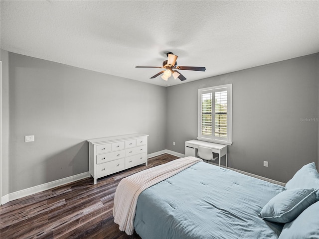 bedroom with ceiling fan, baseboards, dark wood-style flooring, and a textured ceiling