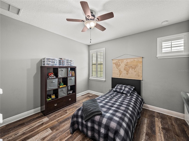 bedroom with visible vents, multiple windows, and wood finished floors