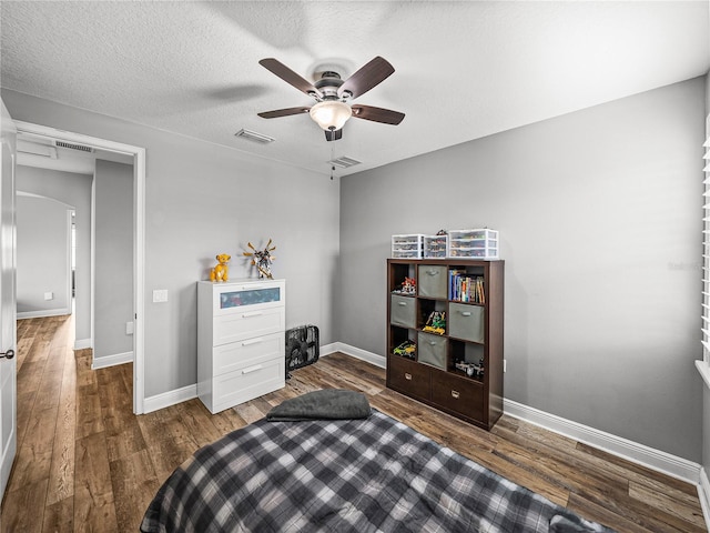 bedroom featuring wood finished floors, visible vents, and baseboards