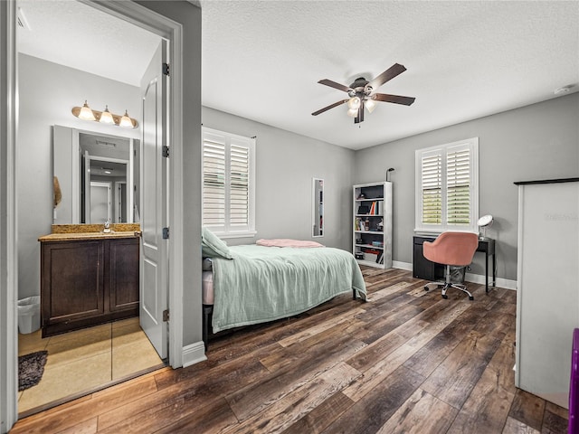 bedroom featuring baseboards, wood-type flooring, a textured ceiling, and a ceiling fan