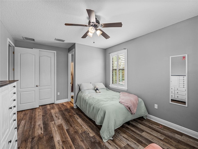 bedroom featuring visible vents, baseboards, and dark wood-style floors