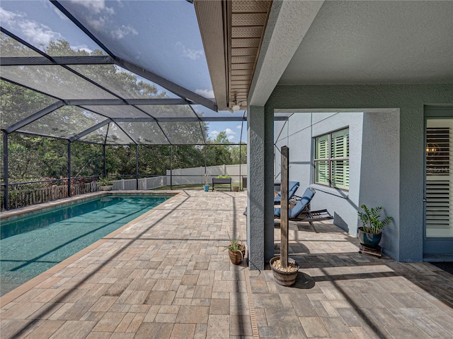 view of swimming pool featuring a patio area, a fenced in pool, glass enclosure, and a fenced backyard