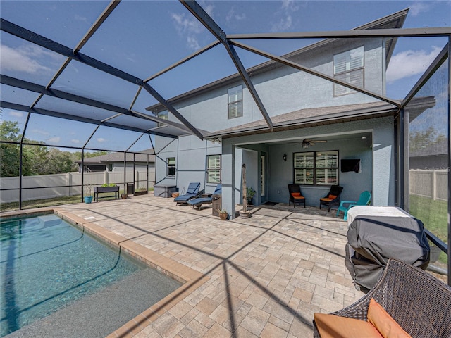 exterior space featuring stucco siding, fence, glass enclosure, and a patio area