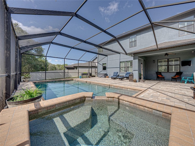 view of swimming pool featuring a lanai, a patio area, and ceiling fan