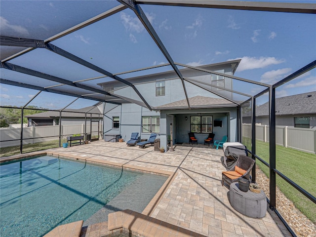 exterior space featuring glass enclosure, a patio, a fenced backyard, and a fenced in pool