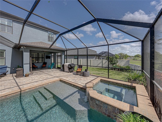 view of pool featuring a lanai, a patio, a fenced backyard, and a pool with connected hot tub