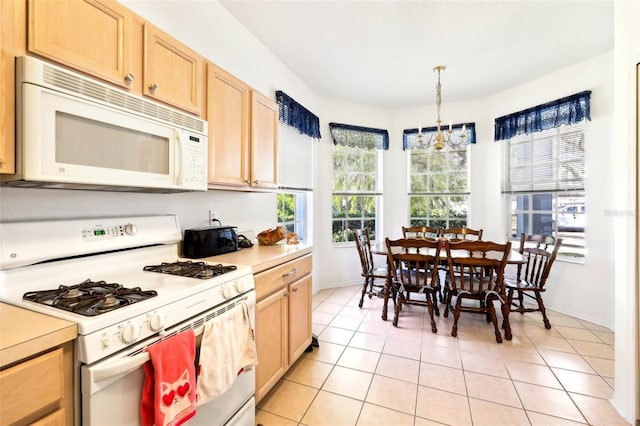 kitchen featuring light tile patterned floors, white appliances, light brown cabinetry, and light countertops