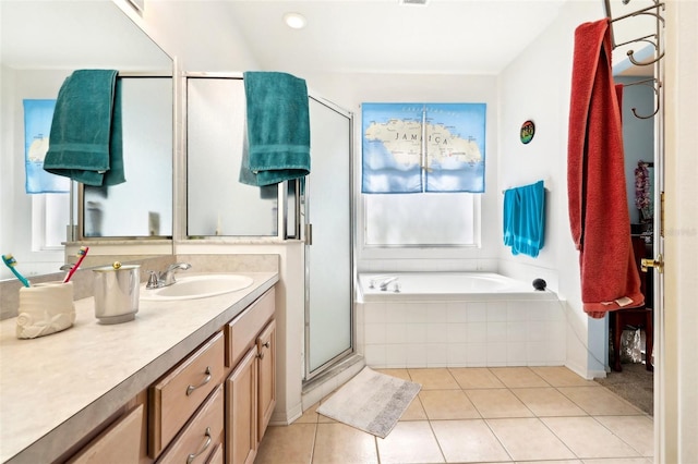 bathroom featuring tile patterned flooring, a stall shower, vanity, and a bath