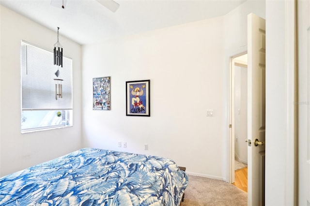 bedroom with ceiling fan, baseboards, and carpet