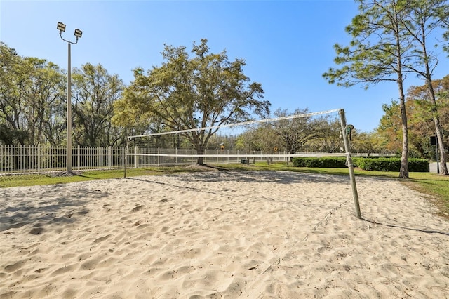 view of community with volleyball court and fence