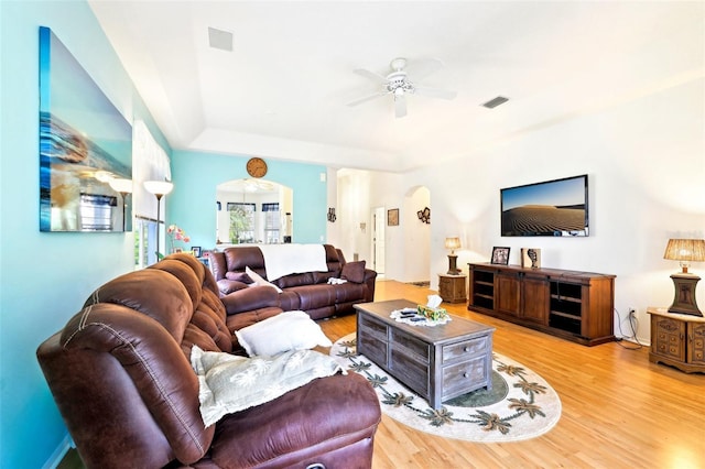 living room with visible vents, ceiling fan, and wood finished floors