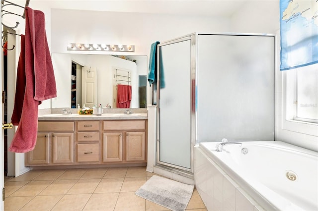 full bathroom featuring a shower stall, double vanity, tile patterned floors, a tub with jets, and a sink