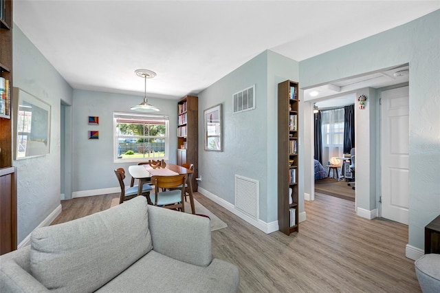 dining room with visible vents, baseboards, and wood finished floors