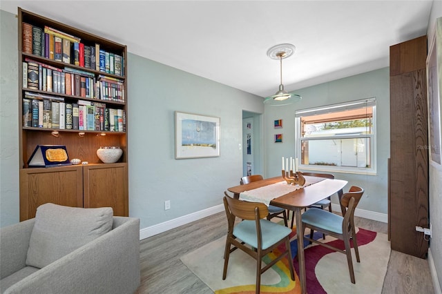 dining room with baseboards and light wood-style floors