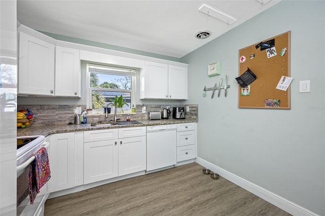 kitchen with visible vents, light wood-style flooring, a sink, white cabinetry, and white appliances