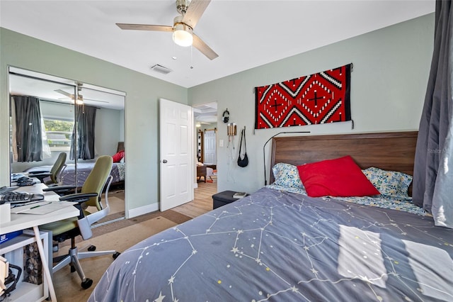 bedroom featuring a ceiling fan, visible vents, a closet, and baseboards