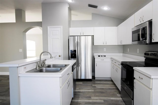 kitchen with visible vents, light countertops, vaulted ceiling, stainless steel appliances, and a sink