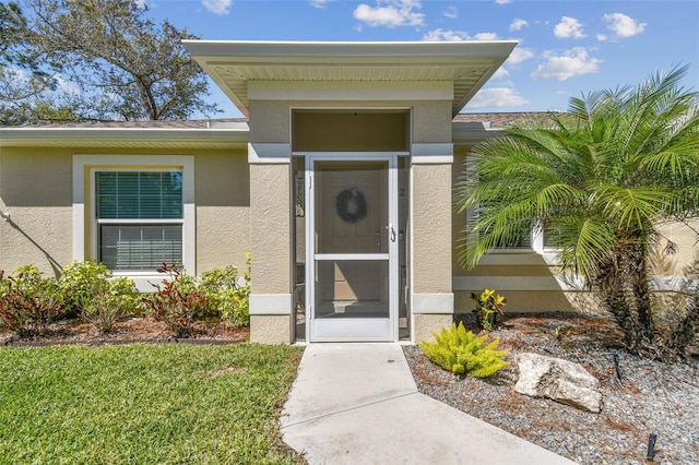 property entrance with stucco siding