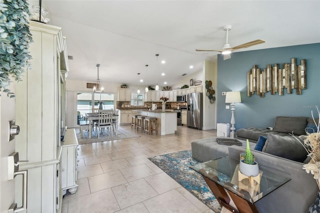 living room with vaulted ceiling, light tile patterned floors, recessed lighting, and ceiling fan