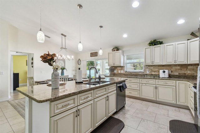 kitchen with dishwasher, an island with sink, lofted ceiling, decorative backsplash, and a sink