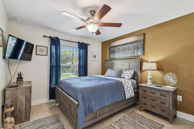 bedroom with light tile patterned floors, baseboards, and ceiling fan