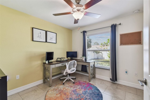 tiled office space featuring baseboards and ceiling fan