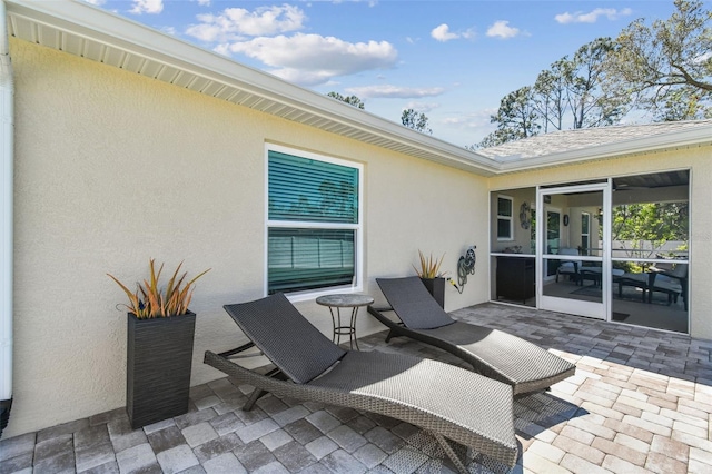 view of patio featuring a sunroom