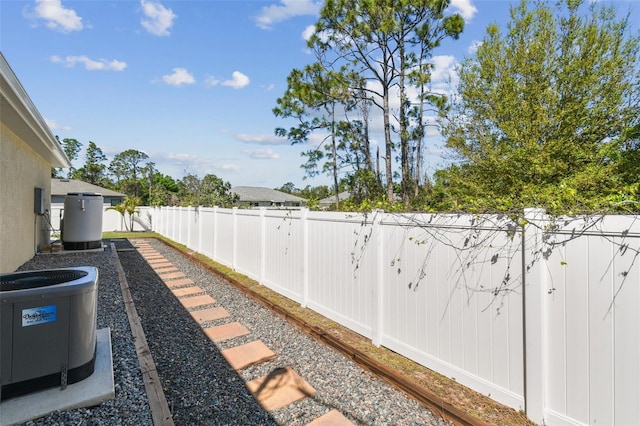 view of yard featuring central air condition unit and a fenced backyard