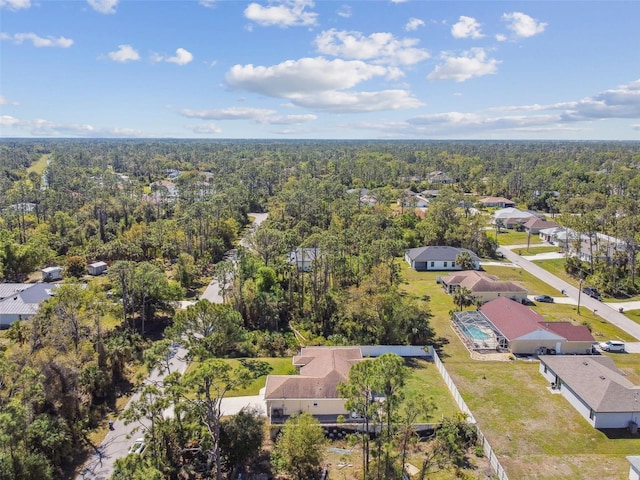 birds eye view of property featuring a wooded view