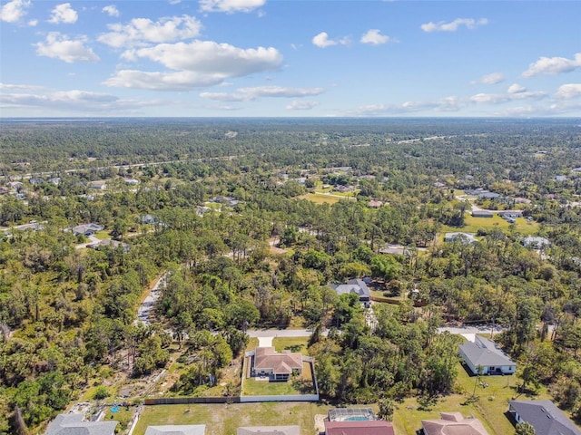 aerial view featuring a wooded view