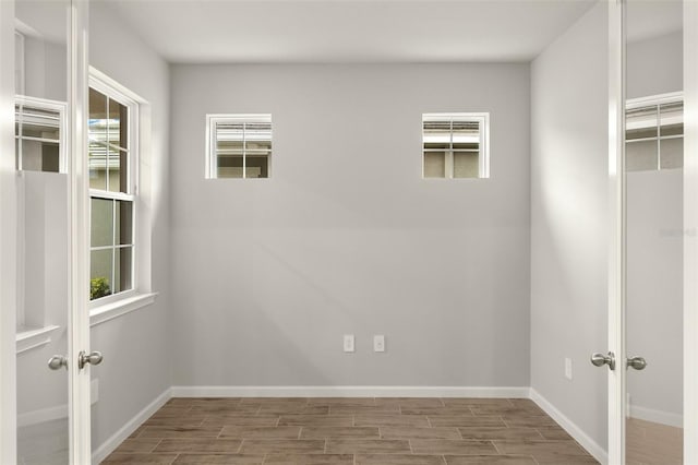 20405 Symphony Pl, Venice, FL 34293 - spare room featuring french doors, baseboards, and wood finish floors