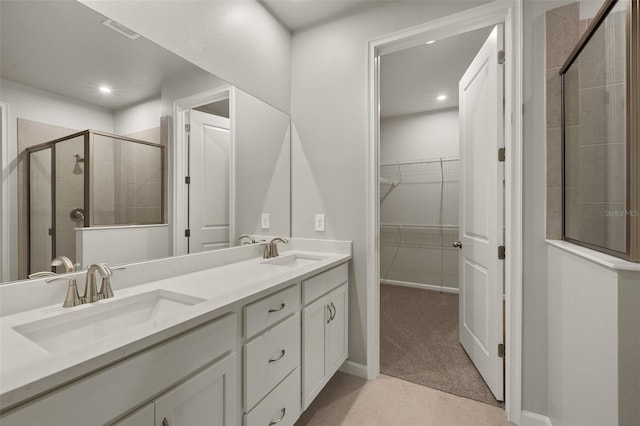 20405 Symphony Pl, Venice, FL 34293 - full bath featuring a shower stall, a walk in closet, visible vents, and a sink