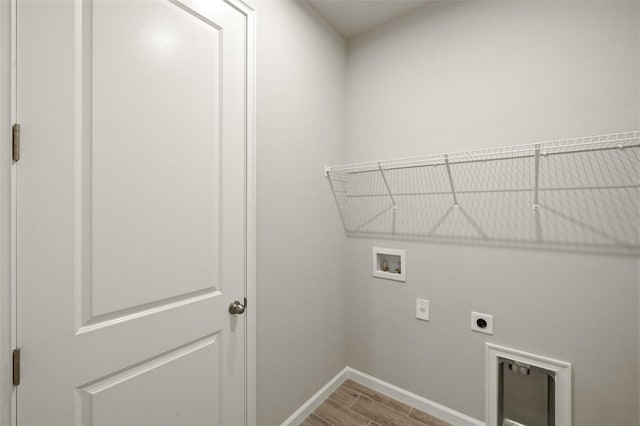 20405 Symphony Pl, Venice, FL 34293 - laundry room featuring baseboards, washer hookup, laundry area, wood tiled floor, and electric dryer hookup