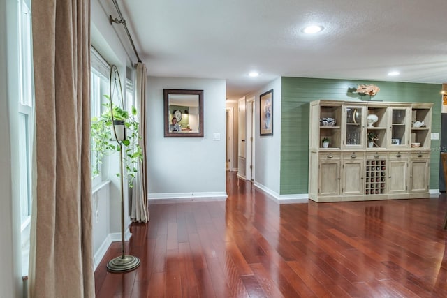 interior space featuring recessed lighting, baseboards, and dark wood-style flooring