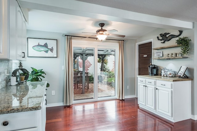 doorway to outside with dark wood-type flooring, baseboards, and ceiling fan